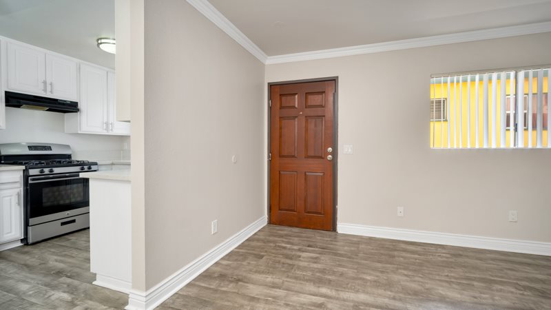 A kitchen with a stove and a door.